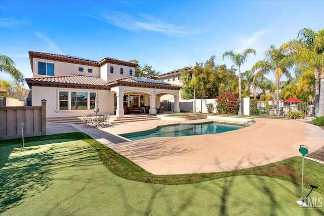 rear view of house featuring stucco siding, a patio, a fenced backyard, a fenced in pool, and a tiled roof