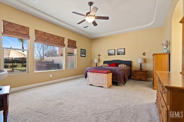 bedroom with carpet flooring, visible vents, a ceiling fan, and baseboards