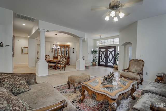 living room featuring french doors, light tile patterned floors, and ceiling fan with notable chandelier