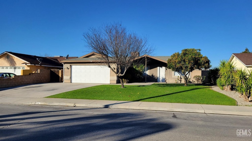 single story home with a garage and a front yard