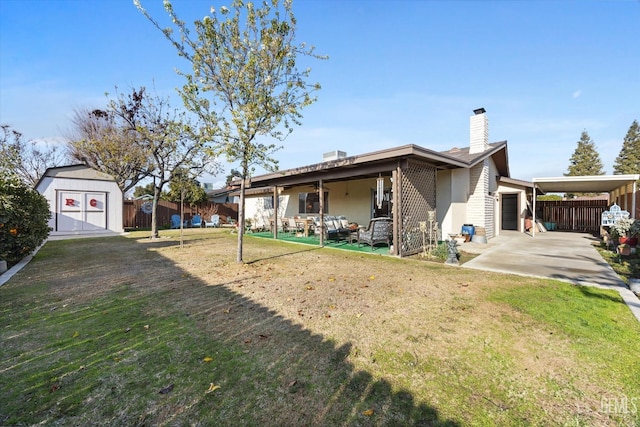 exterior space featuring a storage shed, a yard, and a carport