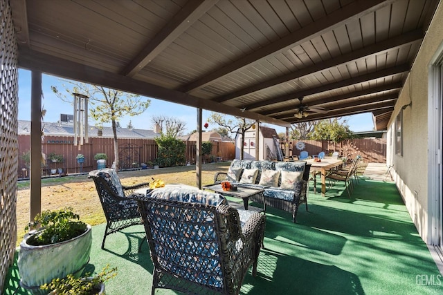 view of patio / terrace with ceiling fan, a storage unit, and an outdoor hangout area