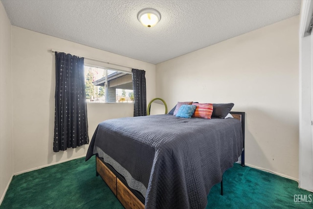 bedroom featuring dark carpet and a textured ceiling