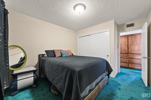 bedroom featuring carpet floors, a closet, and a textured ceiling