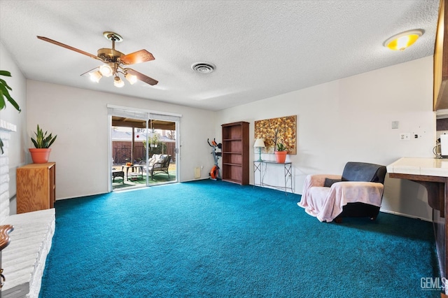 living area with dark colored carpet, ceiling fan, and a textured ceiling