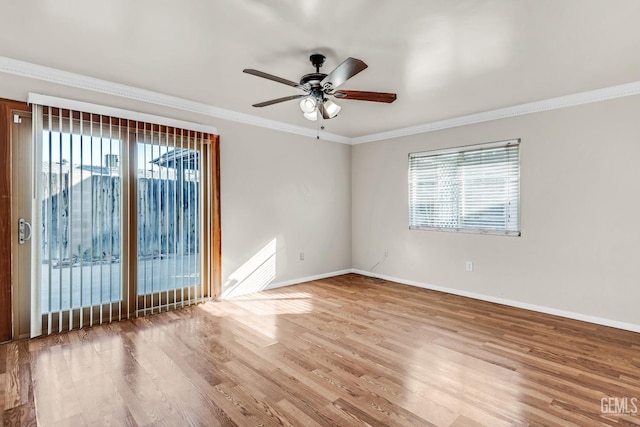 spare room featuring hardwood / wood-style flooring, plenty of natural light, and crown molding