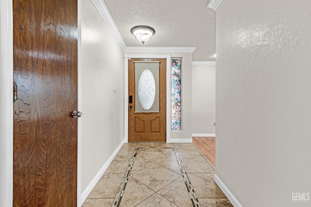 tiled entrance foyer featuring crown molding and a textured ceiling