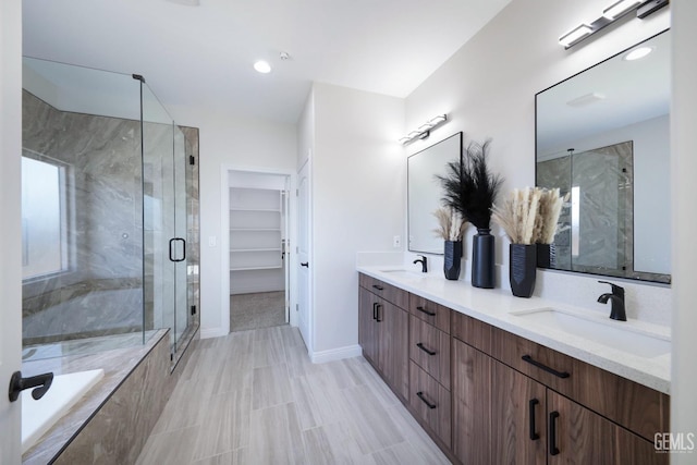 bathroom with shower with separate bathtub and vanity