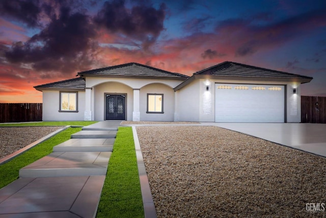 view of front of property with a garage and french doors