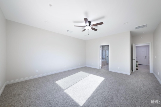 unfurnished bedroom with ceiling fan, light carpet, and connected bathroom