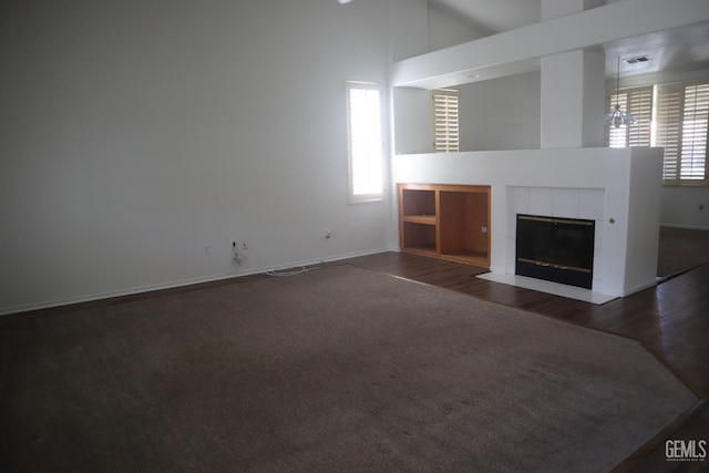 5808 Greenhorn Mountain Ct, Bakersfield, CA 93313 - unfurnished living room with plenty of natural light, high vaulted ceiling, a fireplace, wood finished floors, and carpet flooring