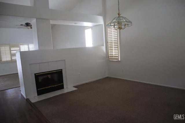 5808 Greenhorn Mountain Ct, Bakersfield, CA 93313 - unfurnished living room featuring a tile fireplace, a chandelier, ceiling fan, and a towering ceiling
