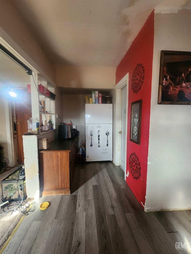 corridor with dark hardwood / wood-style flooring