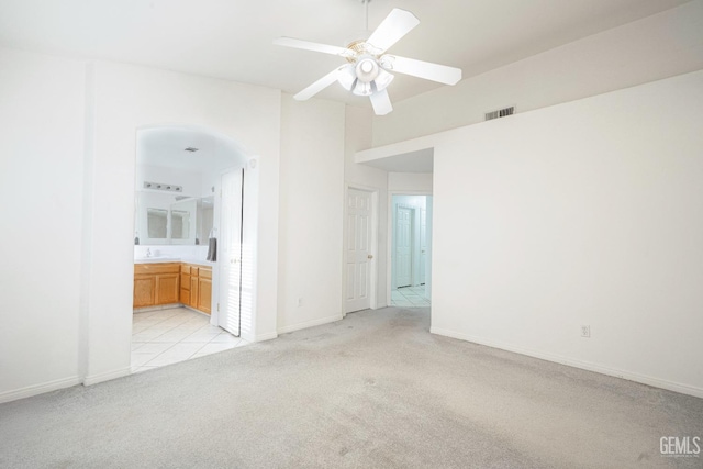 empty room featuring ceiling fan, sink, and light carpet