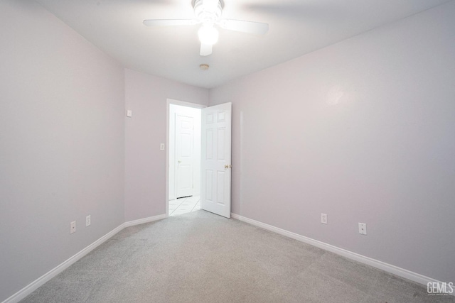 unfurnished room with light colored carpet and ceiling fan