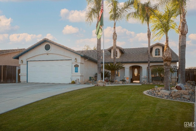 view of front of house with a garage and a front lawn