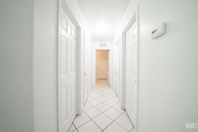 corridor featuring light tile patterned flooring