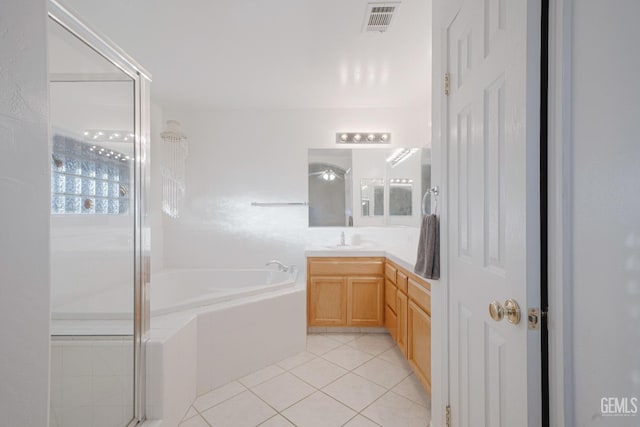 bathroom featuring vanity, plus walk in shower, and tile patterned flooring