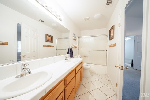 full bathroom featuring toilet, tile patterned floors, shower / bath combination with glass door, and vanity