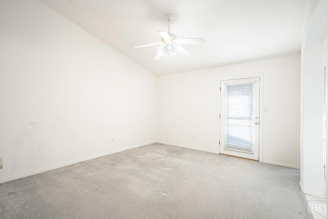 carpeted empty room with ceiling fan and vaulted ceiling