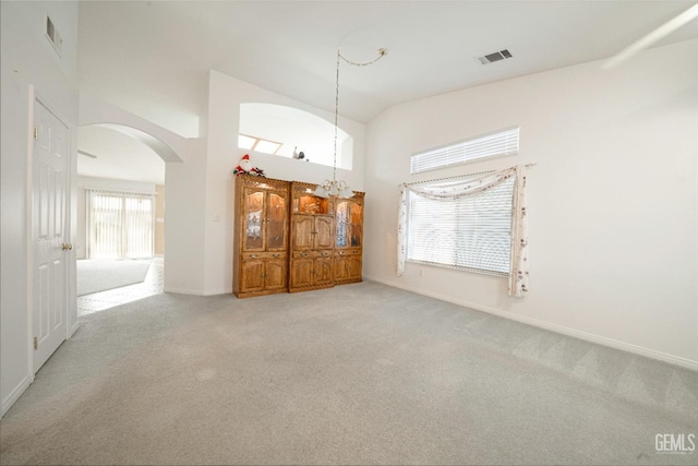 unfurnished room with vaulted ceiling and carpet