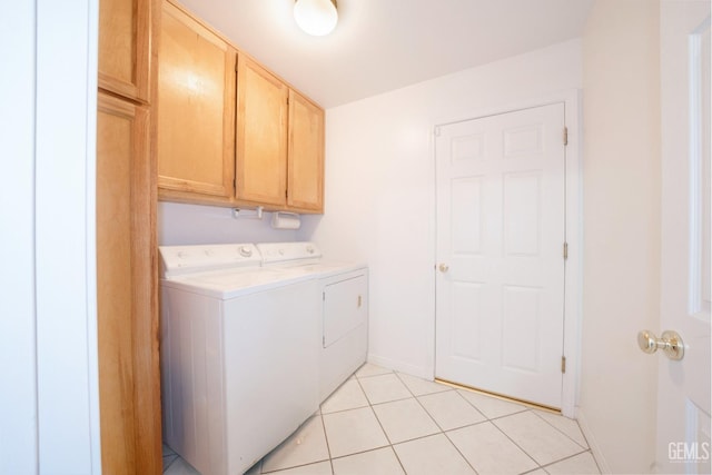 laundry room with light tile patterned flooring, cabinets, and separate washer and dryer