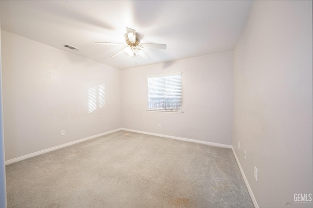 carpeted spare room with ceiling fan