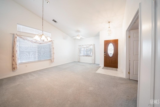 carpeted entryway featuring lofted ceiling