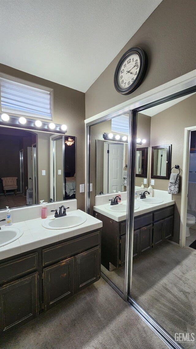3808 Mariana Way, Bakersfield, CA 93311 - bathroom with double vanity, lofted ceiling, toilet, and carpet