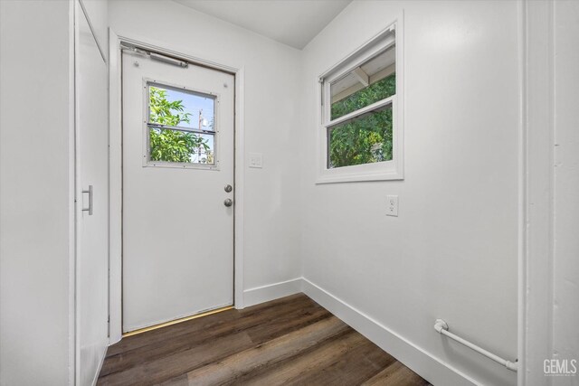 2617 Beech St, Bakersfield, CA 93301 - doorway with baseboards and dark wood finished floors