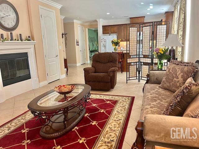 6006 Colchester Pl, Bakersfield, CA 93306 - living area featuring crown molding, recessed lighting, a glass covered fireplace, and light tile patterned floors