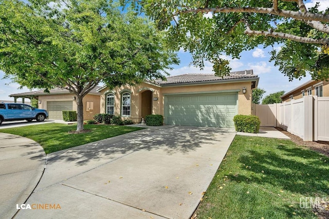 6006 Colchester Pl, Bakersfield, CA 93306 - view of front of property with an attached garage, a tile roof, a front yard, and stucco siding