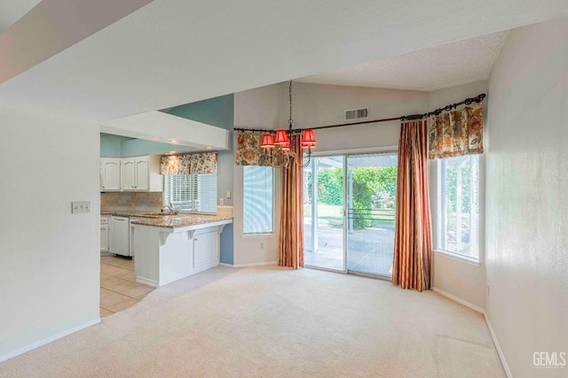 interior space with visible vents, a wealth of natural light, light carpet, and baseboards