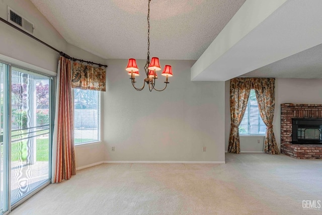 unfurnished dining area featuring a wealth of natural light, carpet, visible vents, and a textured ceiling