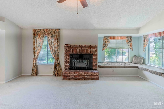unfurnished living room featuring a textured ceiling, carpet, and plenty of natural light