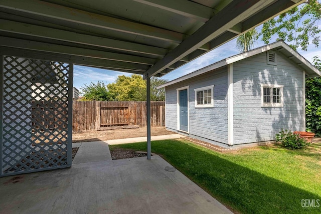 view of patio / terrace with a fenced backyard and an outdoor structure