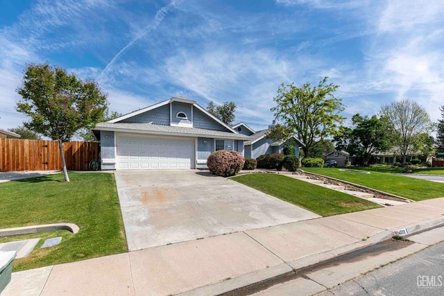 view of front of home with driveway, a garage, a front yard, and fence