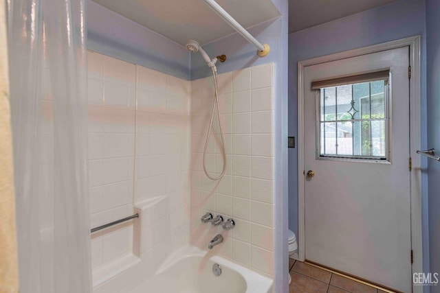 bathroom featuring shower / bath combo, tile patterned flooring, and toilet