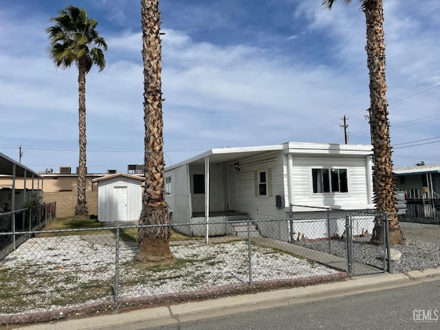 4401 Hughes Ln Unit 116, Bakersfield, CA 93304 - manufactured / mobile home featuring a fenced front yard, a carport, and a storage unit