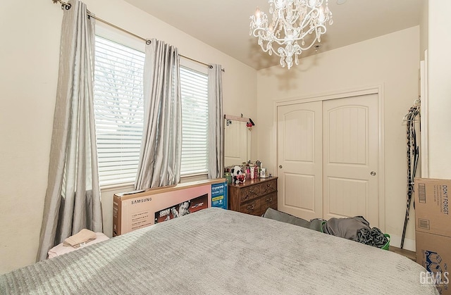 bedroom with a closet and a notable chandelier