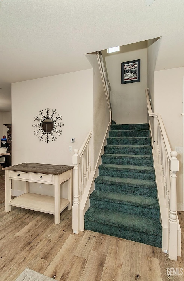 staircase featuring wood finished floors