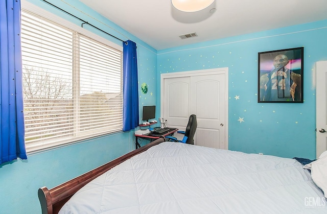 bedroom with visible vents and a closet