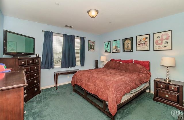 bedroom with baseboards, visible vents, and dark carpet