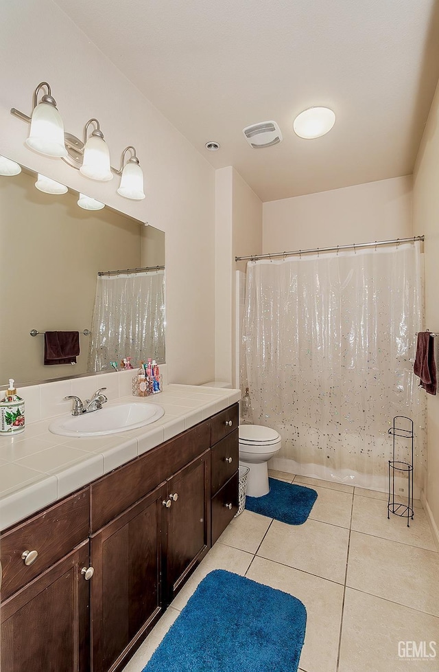 full bathroom with toilet, vanity, tile patterned flooring, and visible vents