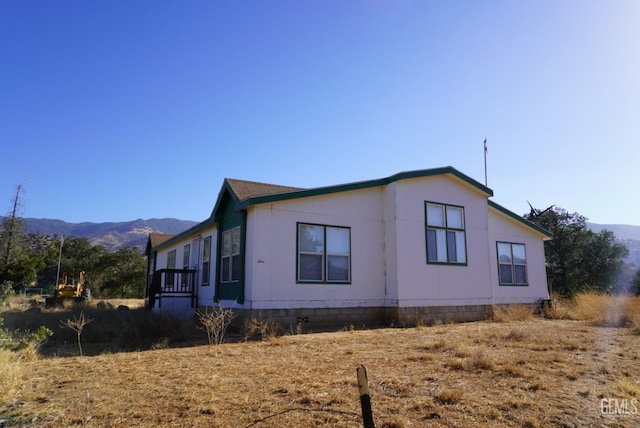 view of property exterior with a mountain view