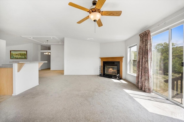 11543 Jay Dr, Caliente, CA 93518 - unfurnished living room with a ceiling fan, a healthy amount of sunlight, a fireplace with flush hearth, and light colored carpet