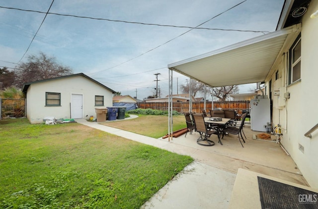 view of yard with a patio area, fence, and an outdoor structure