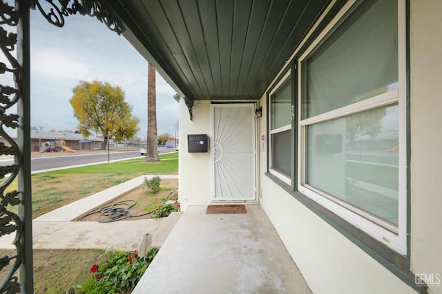 view of exterior entry with a porch