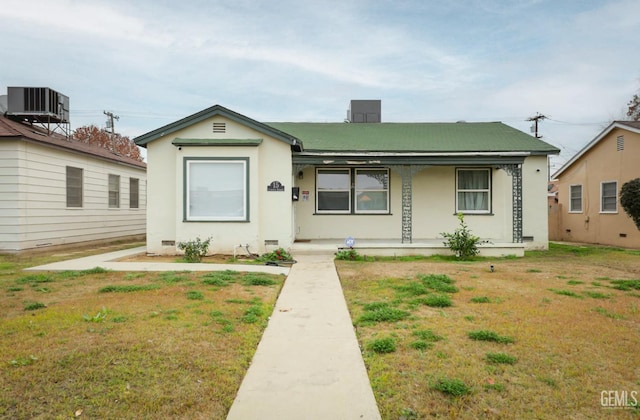 bungalow with covered porch, central AC, and a front yard