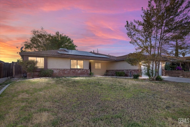 2904 Brock Way, Bakersfield, CA 93306 - ranch-style house with stucco siding, brick siding, fence, solar panels, and a lawn
